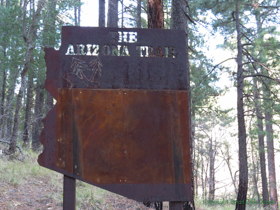 This AZT sign seems to be saying that you just head northwest until you get to two pine trees.  Route finding from here could get a little tricky . . .