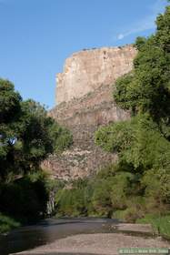 The moon over a cliff in Aravaipa Canyon