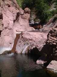 A waterfall dumps into a deep pool on Hannah Creek.