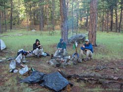 Shan, Estevan and Jerry warm up by the fire.