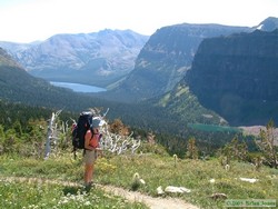 Shan pausing to enjoy the view on her way up to Dawson Pass, with Two Medicine Lake and No Name Lake visible down below.