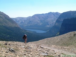 Andrea cruising up to Dawson Pass with Two Medicine Lake visible below.