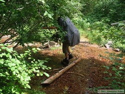 Looking like a huge turtle as I try to stay dry crossing a stream.