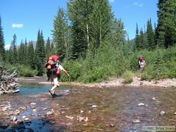 Jerry using his trekking poles to steady himself as he tried to keep dry.