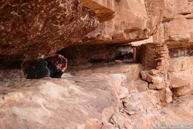 Crazy Steve crawling across a narrow ledge on the upper level of Jailhouse Ruin in Bullet Canyon.