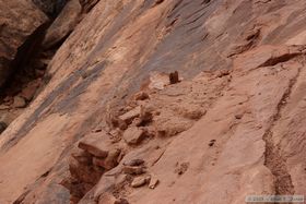 Ladder platform (center) precariously poised on the rock face at Junction Ruin in Grand Gulch.