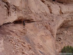 Brian contemplating the high exposure traverse to a ladder base at Junction Ruin.