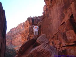 Brian decides to stretch out a bit by climbing this large boulder in the middle of the wash.