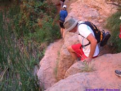 Brad climbing down a little ledge on the trail back to Mooney Falls.