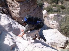 Brian downclimbing a 15 foot dry waterfall.