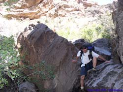 Brian scrambles down some boulders.