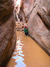 Steve wading through a deep pool in Buckskin Gulch.