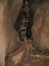 Chuck climbing over a flood debris dam in Buckskin Gulch.