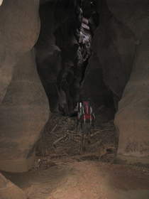 Steve climbing over a large flood debris pile in Buckskin Gulch.