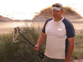 Chuck relocating a Great Basin Rattlesnake (Crotalus oreganus lutosus) in our camp in Paria Canyon.