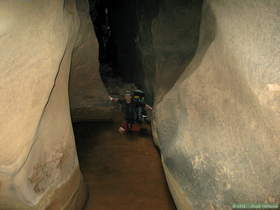 Brian wading through a deep pool in Buckskin Gulch.