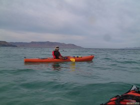 Brian D. searching for stingrays from his yak while Chuck snorkels.