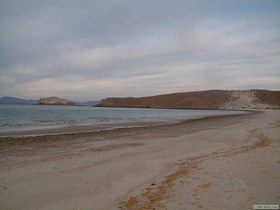 Looking east down the beach with Isla Alcatraz visible to the left of the point.