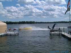 My second cousin Eric blasts the revelers on the water trampoline (at the urging of those of us on shore)