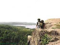 Mosquito net headed Shannon and Brian enjoy the great view of Gunflint Lake and their lodge from the ridgeline