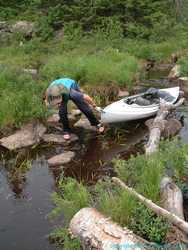 Brian 'float-drags' the yak through a short river portage.